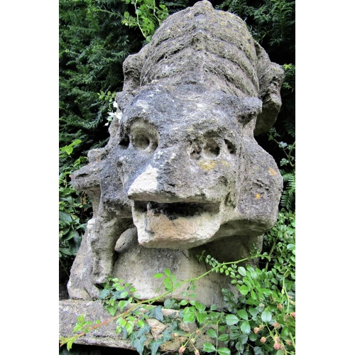 84 - An early limestone carving of a fabulous beast in angry downward pose, 70cm high, overall depth appr... 