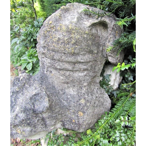 84 - An early limestone carving of a fabulous beast in angry downward pose, 70cm high, overall depth appr... 