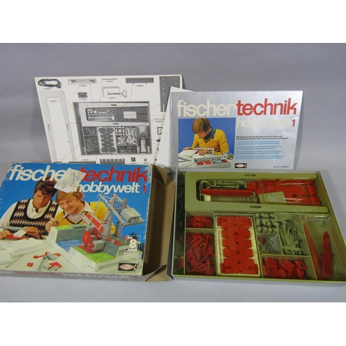 672 - A box of Fischer Technik model building kits, transformer, spare parts, instruction books etc,  unch... 