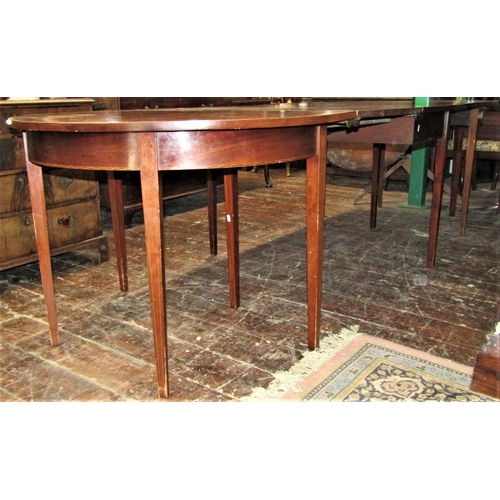 2159 - A Georgian mahogany D end extending dining table crossbanded in satinwood comprising a pair of D end... 