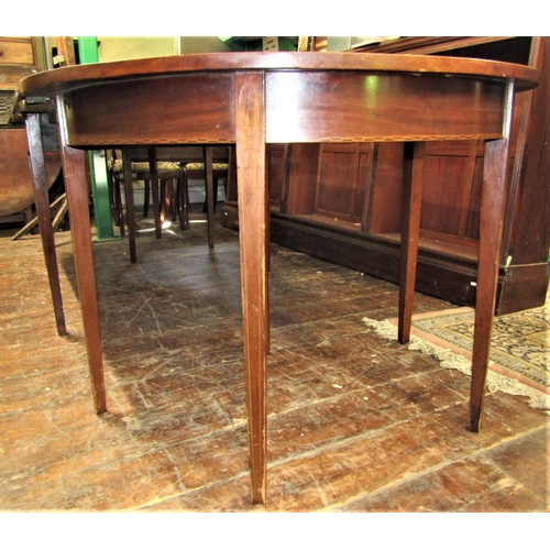 2159 - A Georgian mahogany D end extending dining table crossbanded in satinwood comprising a pair of D end... 