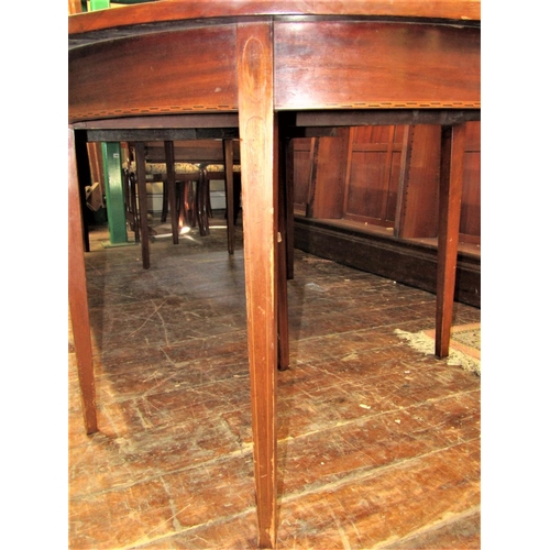 2159 - A Georgian mahogany D end extending dining table crossbanded in satinwood comprising a pair of D end... 