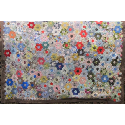 483 - Vintage traditional patchwork quilt with multi coloured hand stitched hexagonal 'flowers' surrounded... 