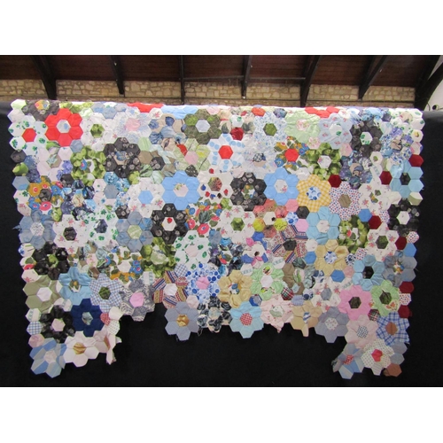 493 - A partially completed patchwork quilt, unlined and unfinished; stitched area is approx. 100 x 140 cm... 