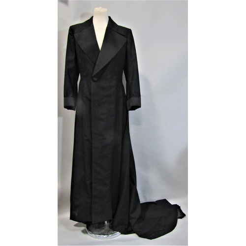 492 - Ladies vintage full length coat with train, in black textured fabric with satin collar, cuffs and co... 