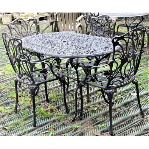 1574 - A contemporary cast aluminium garden terrace table of oval form with decorative pierced foliate scro... 