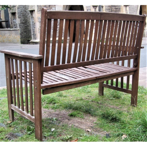 1554 - A contemporary weathered hardwood two seat garden bench with slatted seat, back and arms, (af) 126cm... 