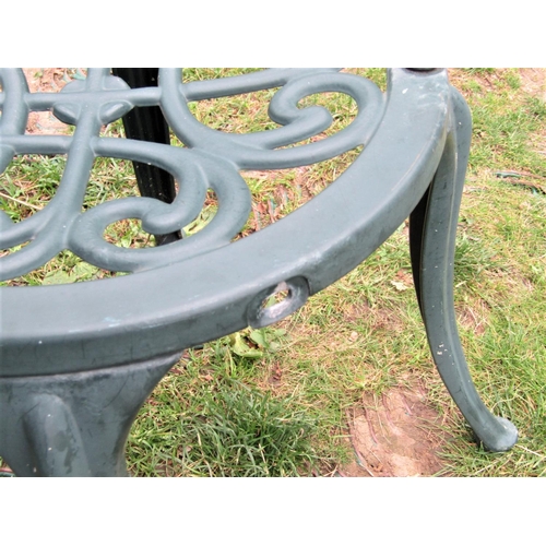 1558 - A contemporary green painted cast aluminium garden terrace table with decorative tight scroll radiat... 