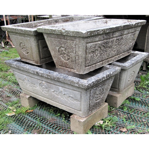 1566 - A set of four reclaimed garden planters of rectangular and tapered form with foliate detail, 82cm lo... 