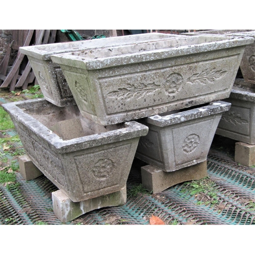 1567 - A set of four reclaimed garden planters of rectangular and tapered form with foliate detail, 82cm lo... 