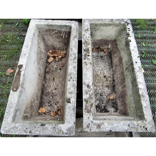 1567 - A set of four reclaimed garden planters of rectangular and tapered form with foliate detail, 82cm lo... 