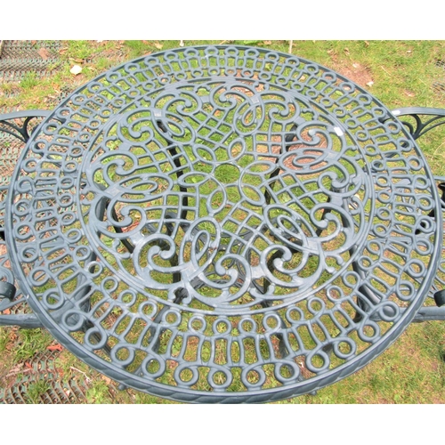 1582 - A contemporary green painted cast aluminium three piece garden terrace set comprising a table with d... 