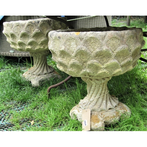 1564 - A pair of reclaimed garden urns, with circular repeating shell relief bowls, raised on wrythen shell... 