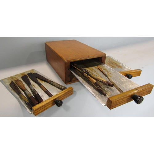 460 - A small pine tower of three drawers each holding a selection of oiling or calligraphy brushes 18cm m... 