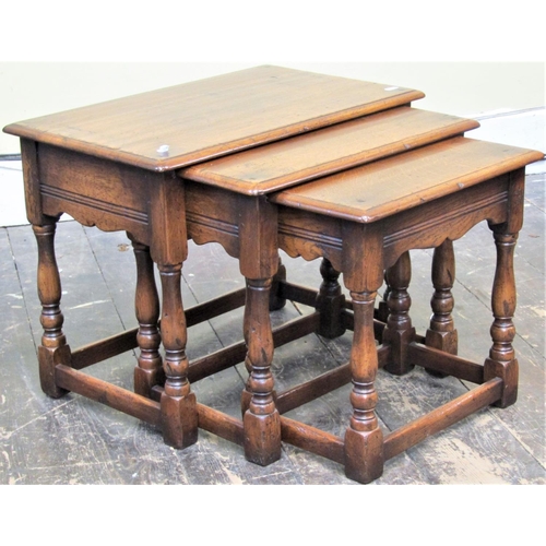 2138 - A good quality nest of three graduated occasional tables in the antique style raised on baluster sup... 