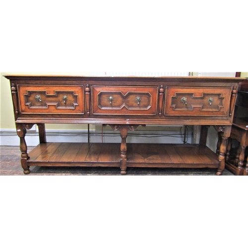 2139 - A good quality oak dresser base in the Jacobean style fitted with three frieze drawers with applied ... 