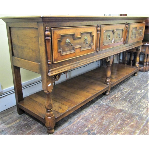 2139 - A good quality oak dresser base in the Jacobean style fitted with three frieze drawers with applied ... 