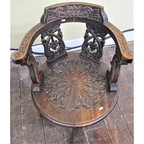 2140 - A Victorian oak office chair, the circular seat supporting a horseshoe shaped back with carved and p... 