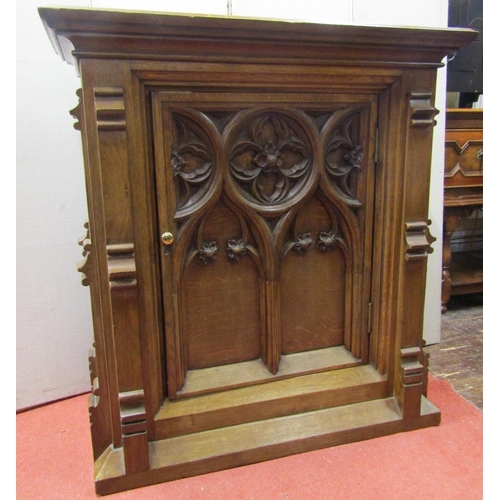 2150 - A Victorian oak cabinet with Gothic tracery detail, enclosed by a single door with further applied m... 