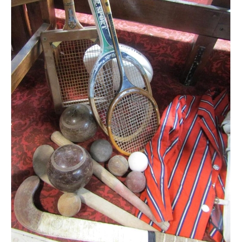 524 - A mixed sporting lot comprising cricket pads and bat, tennis rackets, a boating blazer, rugby ball, ... 