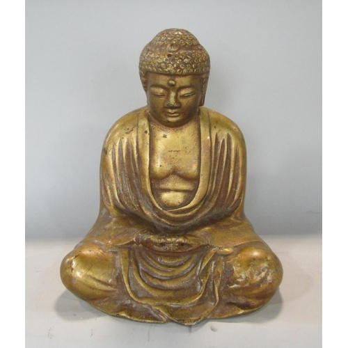 533 - A gilt metal study of a seated Buddhistic deity, 27 cm high