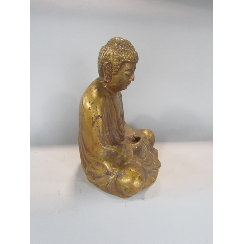 533 - A gilt metal study of a seated Buddhistic deity, 27 cm high