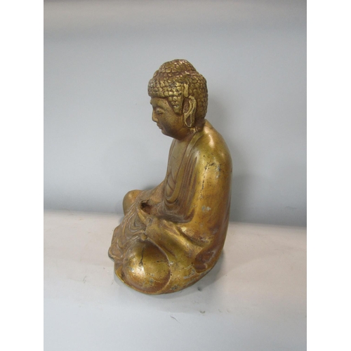 533 - A gilt metal study of a seated Buddhistic deity, 27 cm high