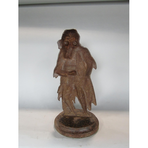 540 - A figural cast iron fire iron holder in the form of a fagan looking character, 38 cm high