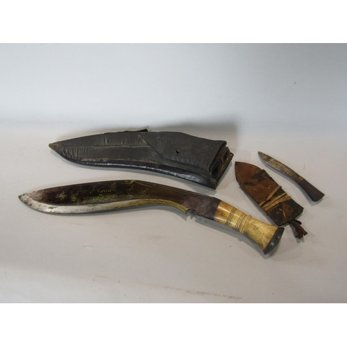 563 - A Kukri within leather sheath, 41cm long