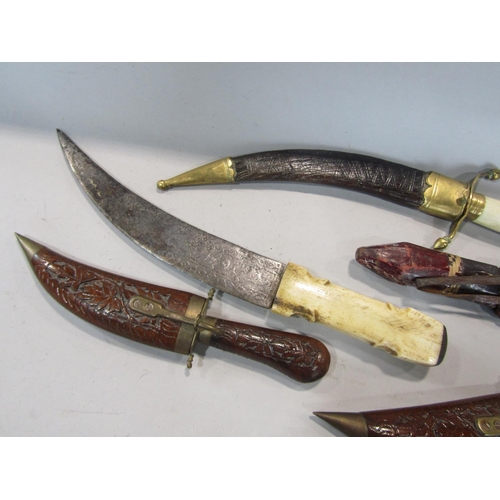 596 - A collection of eastern daggers (5)