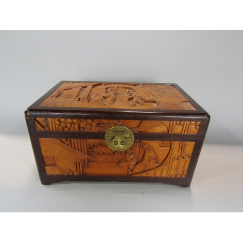 601 - Chinese carved camphor wood table top casket, decorated with figures in an interior and exterior set... 