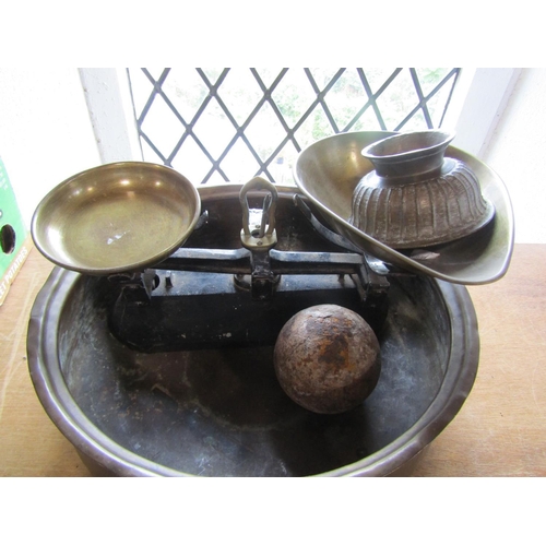 606 - A mixed lot to include an antique cannon ball, a bronze pedestal dish, a pair of weighing scales and... 