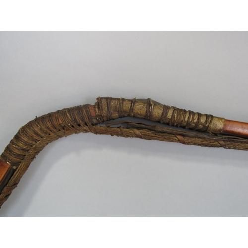 622 - An antique inuit bow in cedar wood, with additonal hide and plaited cord detail, 123 cm in length