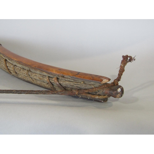 622 - An antique inuit bow in cedar wood, with additonal hide and plaited cord detail, 123 cm in length