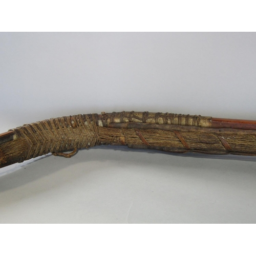 622 - An antique inuit bow in cedar wood, with additonal hide and plaited cord detail, 123 cm in length