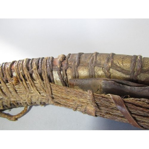 622 - An antique inuit bow in cedar wood, with additonal hide and plaited cord detail, 123 cm in length