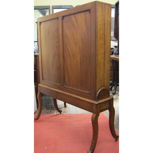 2168 - A Regency mahogany folio or print stand, raised on four swept supports, with panelled frame and well... 