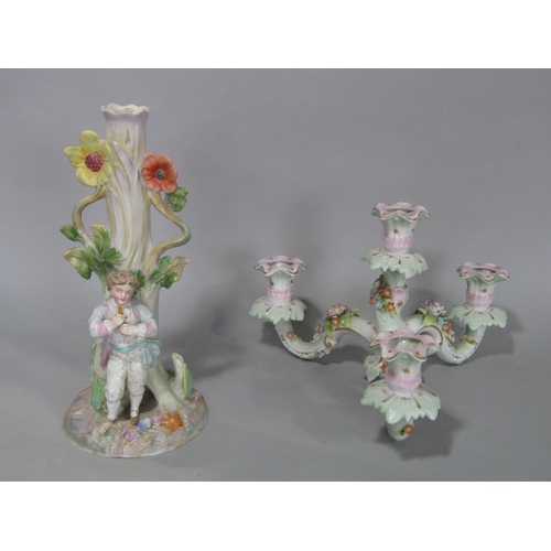 100 - A late 19th century German porcelain three branch candelabra with a piper standing beneath a tree, t... 