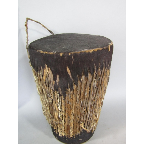 545 - Tribal interest - hide covered drum, 27 cm high, together with a further hide shield 79 cm long (2)