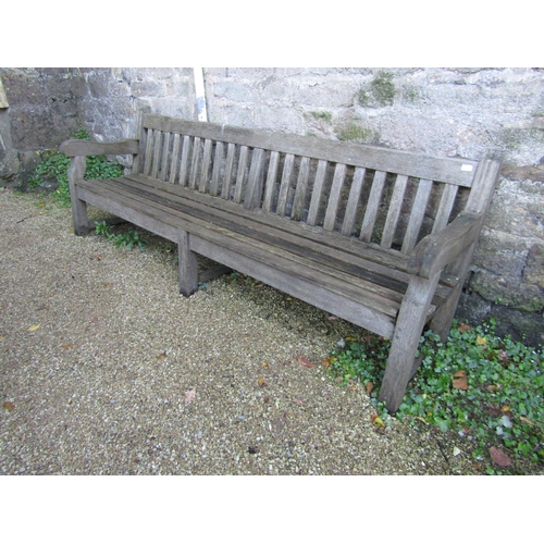 87 - A good quality teak garden bench, 240cm long approx