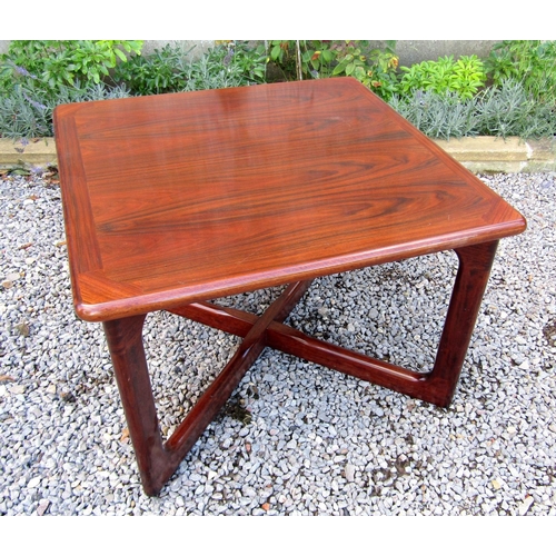 194 - Dyrlund of Denmark solid rosewood coffee table, the moulded top with four moulded united by a shaped... 