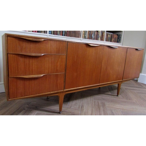 219 - McIntosh teak sideboard fitted with two cupboard doors, a fall door and three short drawers, upon ta... 