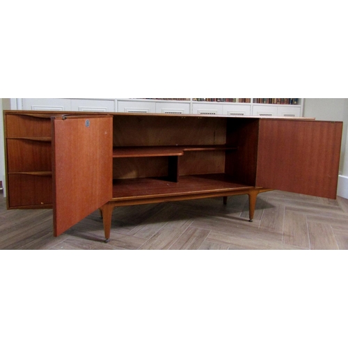 219 - McIntosh teak sideboard fitted with two cupboard doors, a fall door and three short drawers, upon ta... 