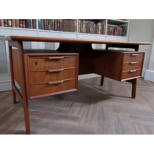 221 - Gunni Omann teak twin pedestal desk, the floating top over two pedestals fitted with three short dra... 