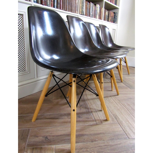 223 - Set of four Eames style Eiffel dining chairs with charcoal fiberglass moulded seats upon four beech ... 