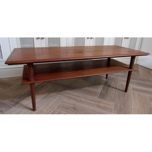 229 - Danish teak two tier long coffee table upon circular tapered legs, 122cm long x 45cm high x 50cm wid... 