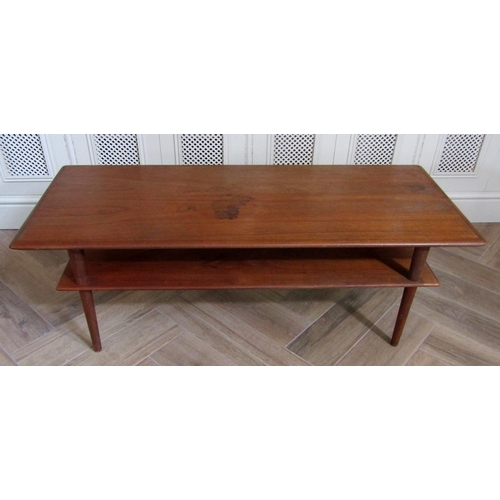 229 - Danish teak two tier long coffee table upon circular tapered legs, 122cm long x 45cm high x 50cm wid... 