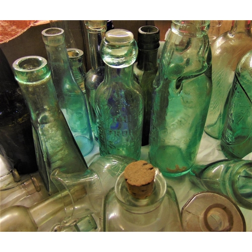 1140 - A mixed collection of various antique and vintage glass advertising and collectors bottles