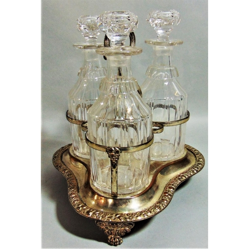 1173 - Good quality antique silver plated three decanter bottle cruet, the frame with scrolled acanthus and... 