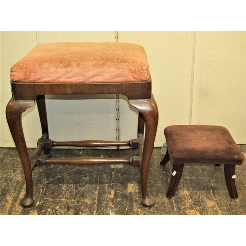 2745 - A Georgian walnut stool of rectangular form, with loose seat, raised on four pad feet, united by joi... 